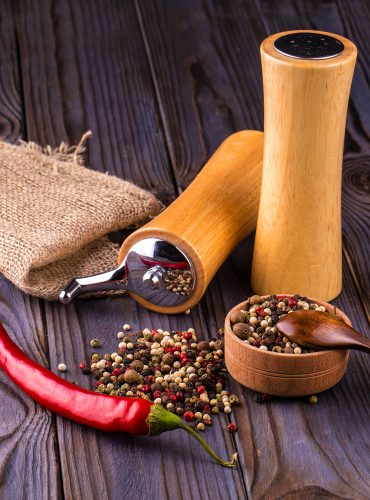 red chili peppers in a canvas sack on wooden table.